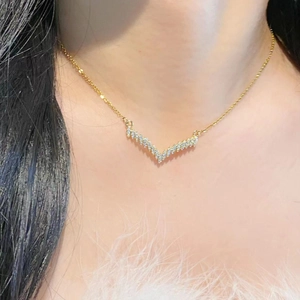Elegant gold V-shaped chevron necklace with shimmering micro-pave cubic zirconia crystals