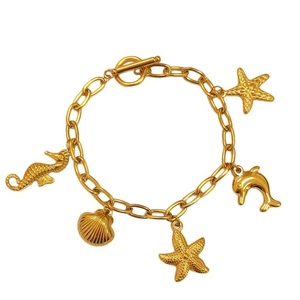 Gold ocean series necklace with sea horse star and shell pendants on a white background