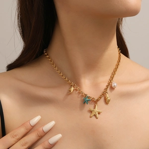 Gold ocean themed necklace with starfish, seashell and pearl on wide link chain for women