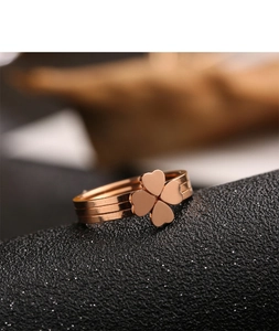 Macro shot of rose gold four-leaf clover ring with layered triple-band design