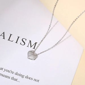 Detailed macro view of heart pendant necklace with shimmering cubic zirconia micro-paving