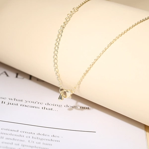 Detail of 14K gold plated necklace showing lobster clasp and water drop metal pendant