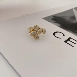 Detailed view of rotating golden windmill ring with sparkling pavé zircons