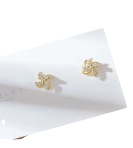 Golden rotating windmill stud earrings with sparkling crystals for a lucky jewelry look