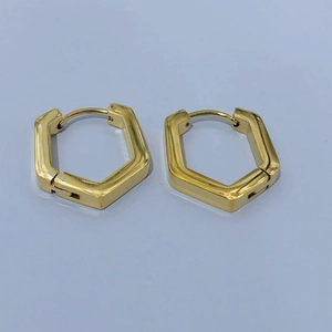 Detailed view of polished gold hexagonal geometric hoop earrings with a secure clasp closure