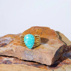 Macro detail of bohemian gold multi-band ring with a large teardrop aqua blue natural stone