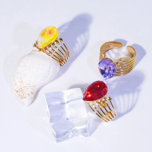 Detailed top view of three vintage teardrop gemstone rings with gold multi-layer bands