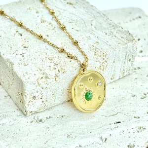 Vintage 14K gold plated sunburst necklace with green stone and sparkling crystal detail