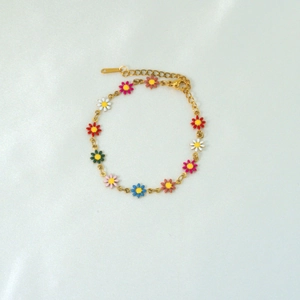 Detail showing colorful enamel daisies on a gold-plated adjustable chain bracelet