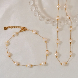 Elegant natural pearl jewelry set with stainless steel necklace and bracelet on silk