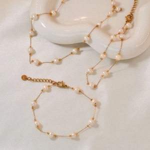Elegant gold-plated stainless steel necklace and bracelet set with delicate white pearls