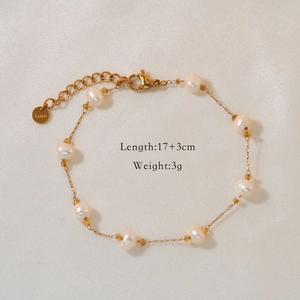 Detailed macro view of natural pearl bracelet with gold stainless steel chain and clasp
