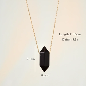 Detailed shot of a black hexagonal stone pendant with gold paperclip chain and measurements