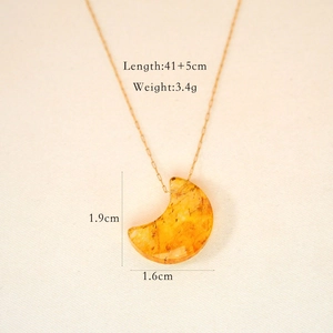 Detail showing the 41+5cm gold chain length and 1.9cm amber crescent moon pendant