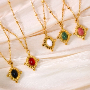 Macro detail of vintage style necklaces with oval gemstones on satellite chains