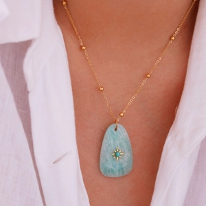 Detail of Amazonite stone pendant with starburst on golden beaded stainless steel chain