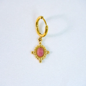 Detail of vintage 14k gold plated earring with pink faceted stone and cross sunburst design