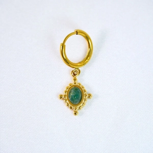 Close-up of European court style gold earring with green stone and vintage beadwork