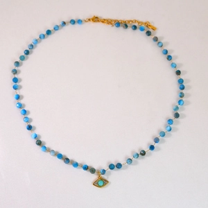 Detailed shot of Amazonite beaded necklace with golden 14K evil eye charm pendant