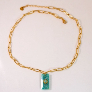 Detail of 14K gold paperclip chain necklace with green amazonite and sun pendant