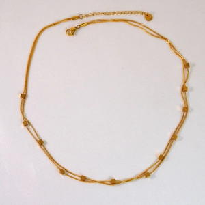 Close-up of a double-layered 14K gold-plated stainless steel necklace with cube beads