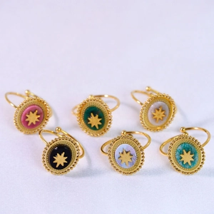 Detail view of colorful natural stone starburst rings with 14k gold plated edges