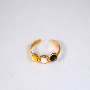 Detail of 14K gold stainless steel ring with yellow, white, and black shell inlays