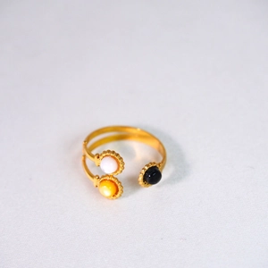 Detail of 14K gold plated stainless steel open ring with white, yellow, and black shells
