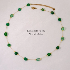 Detailed close-up of green natural stone beads and gold stainless steel chain with S.steel tag