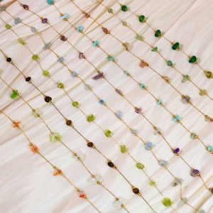 Handmade necklace with natural colorful gravel stones on a minimalist gold chain link