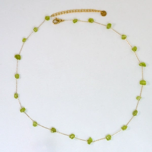Detail of handmade gold chain necklace with light green natural stone chips and lobster clasp