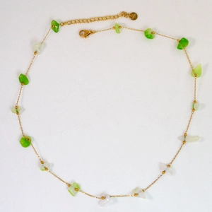 Close-up of gold chain with green beads and S.steel hallmark on the lobster clasp