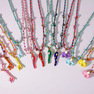 Colorful handmade woven cord necklaces with enamel animal pendants in 12 vibrant styles