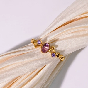 Vintage style gold stainless steel ring with oval purple gemstone on silk