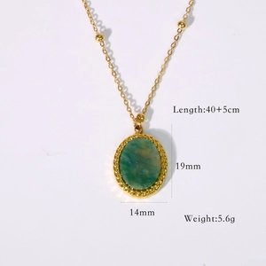 Macro detail of French vintage gold necklace with oval green stone pendant and dimensions