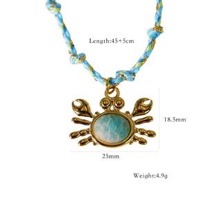 Detailed view of crab pendant with natural blue stone and dimensions for sizing