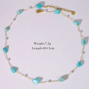 Detailed view of ocean-style necklace with blue stones, pearls, and gold extension chain