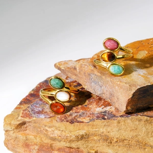 Gold plated titanium steel ring featuring three oval multi-color natural stone inlays