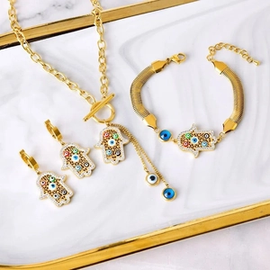 Detailed set of gold Hamsa necklaces and bracelets with colorful evil eye charms