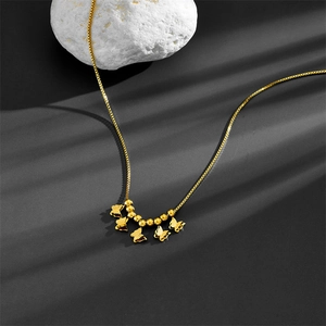Elegant gold butterfly box chain necklace with five butterfly pendants on a stone