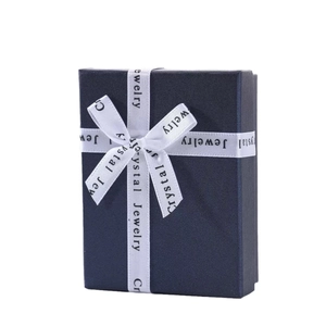 Premium navy blue jewelry gift box with a white satin ribbon and silk bow detail