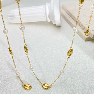 Golden titanium steel long necklace with white pearls and coffee bean links on stone decor