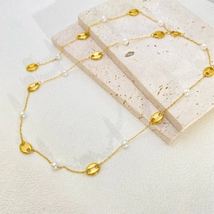 Elegant 18k gold plated titanium necklace with pearls and coffee bean links on marble