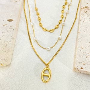 Layered gold titanium steel necklace set with pearls, pig nose links and oval pendants