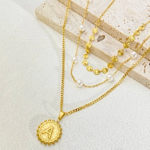 Three-layer gold titanium necklace featuring a pearl strand and a letter A coin pendant