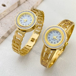 Gold-tone stainless steel quartz watch set with crystal-inlaid bezel and meander pattern