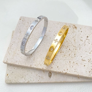 Titanium steel bangles with sparkling zircon clover patterns in gold and silver finishes