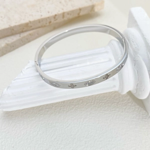 Detailed close-up of a silver-tone steel bangle featuring marquise cubic zirconia inlay