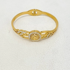 Close-up of golden Tree of Life steel bangle with shimmering crystal pavé details