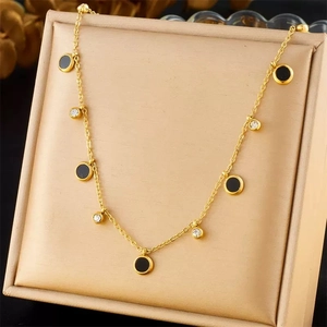 Chic gold titanium necklace with black enamel discs and white zircon crystal pendants